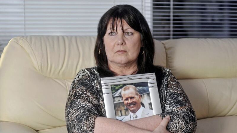 Kate Carroll holds a picture of her murdered husband Stephen Carroll in 2010. Picture by Colm Lenaghan/Pacemaker 
