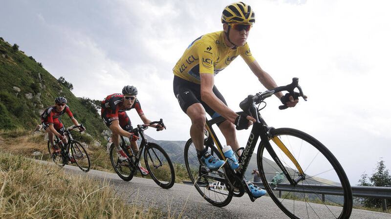 Chris Froome, wearing the overall leader&#39;s yellow jersey, is followed by Tejay van Garderen of the United States, far left, as they speed downhill during day 12 of the Tour de France 