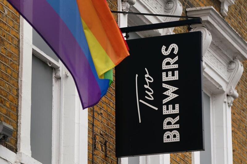 The Two Brewers sign with the rainbow pride flag visible next to it.