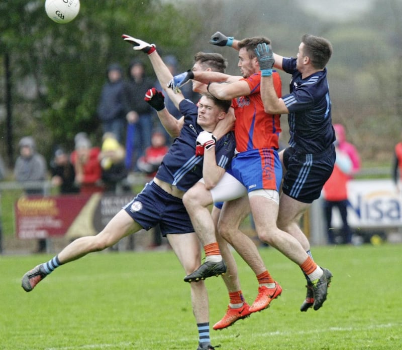 Shay McGuigan. pictured centre battling for possession, was the top scorer in the Tyrone championship 