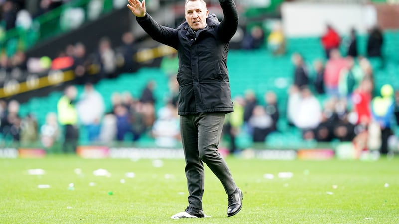 The Celtic manager greets the crowd after a 3-0 win