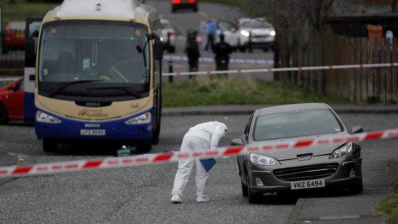 A forensic officer examines the scene after a man was shot outside St Brendan&#39;s Primary School in Lurgan, Co Armagh. Picture by Cliff Donaldson 