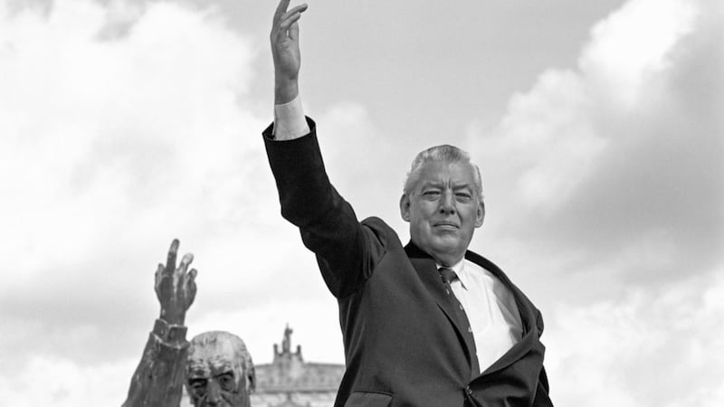 Ian Paisley pictured at Edward Carson&#39;s statue at Stormont in 1985. A machine was used to lift the late DUP leader to the height of the statue. Picture from Bobbie Hanvey Photographic Archives, John J. Burns Library, Boston College, Courtesy of the Trustees of Boston College 