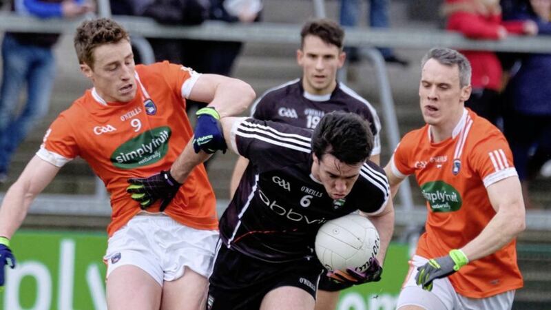 Armagh&#39;s Charlie Vernon and Mark Shields keep Sligo&#39;s Darragh Cummins under tabs at the Athletic Grounds. Armagh eased to a 2-17 to 0-9 win 
