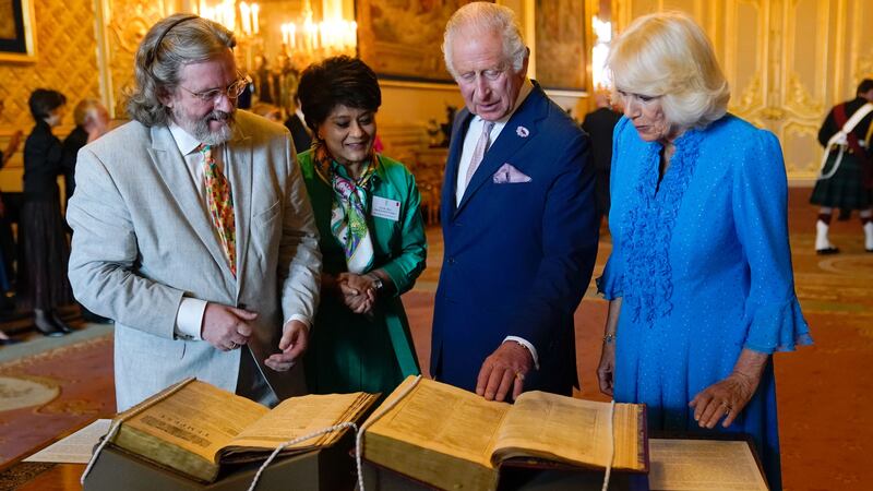 The King and Queen are shown a first and second folio of works by William Shakespeare by Gregory Doran, director of the Royal Shakespeare Company, left, and Baroness Vadera, chair of the Royal Shakespeare Company, during a reception at Windsor Castle (Andrew Matthews/PA)