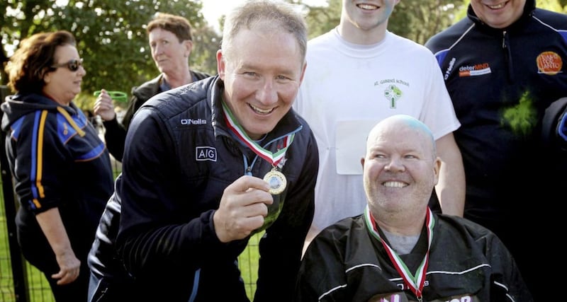 Dublin manager Jim Gavin shows Anto Finnegan his medal for completing the &#39;Run For Anto&#39; event in Falls Park, Belfast, the proceeds of which went to the Motor Neurone Disease charity deterMND. Picture by Ann McManus. 