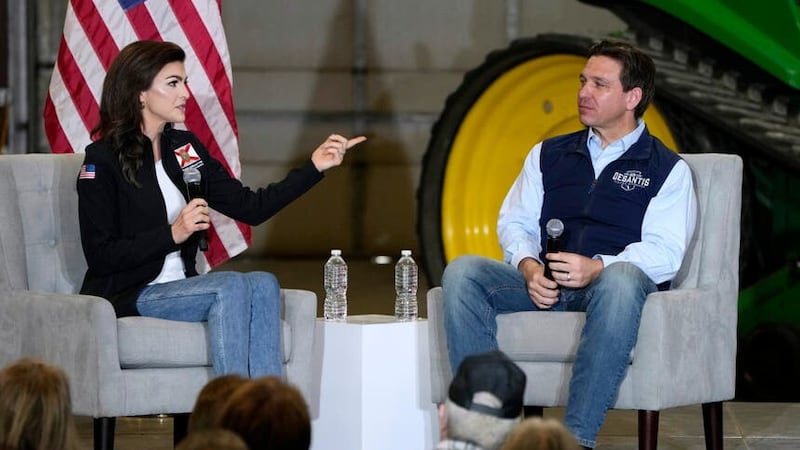 Republican presidential candidate Ron DeSantis talks with his wife Casey, left, during a campaign event in Salix, Iowa (Charlie Neibergall/AP/PA)