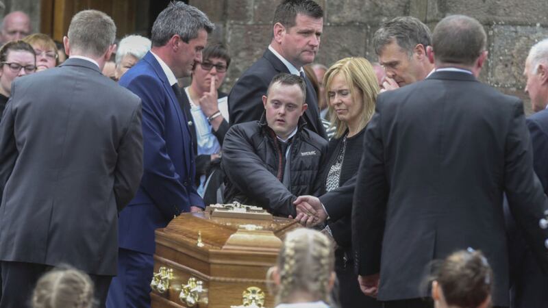Concepta Leonard's son Conor, who was injured in the attack, walks alongside his mother's coffin Picture by Hugh Russell&nbsp;