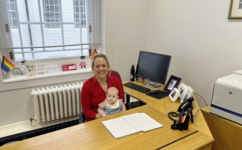 Kate Nicholl pictured at work with her baby daughter Étaín
