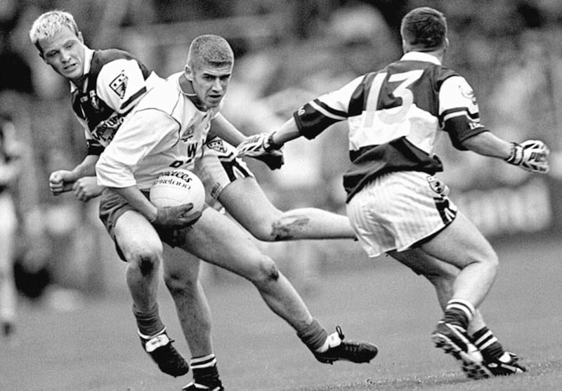CAUGHT RED HANDED...Laois Minors found the power and pace of Tyrone to much in yesterday&rsquo;s Minor Final as Tyrone&#39;s Kevin Hughes (above) evades Laois defenders John Behan and John McDonald to set up an attack 
