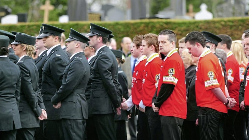 A joint guard of honor from Ronan Kerr&#39;s GAA team and his PSNI colleagues at his funeral Mass. Picture By: Arthur Allison. 