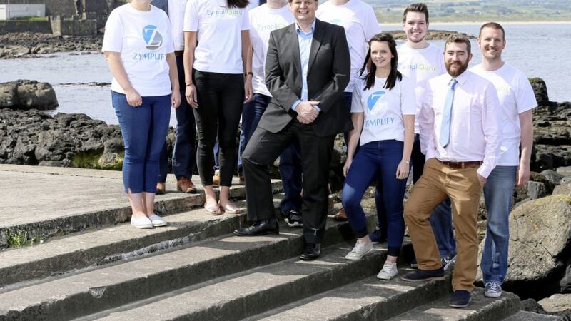 CEO of Zymplify Michael Carlin pictured with his current team at Zymplify in Portstewart. The firm has confirmed recruitment has begun for 15 new positions at the company 