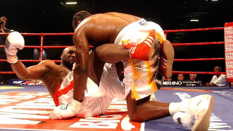 Audley Harrison (right) falls on top of Danny Williams during their Commonwealth heavyweight title fight at the ExCel Arena in London Saturday December 10 2005. Williams seized the Commonwealth heavyweight title and dealt Harrison his first professional defeat