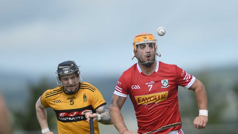 Loughgiel began their Championship campaign with a 3-23 to 1-22 victory over St Enda's. Pictured is Loughgiel's Caolan Blair getting away from St Enda's Eoin Conlon.  Picture: Mark Marlow 