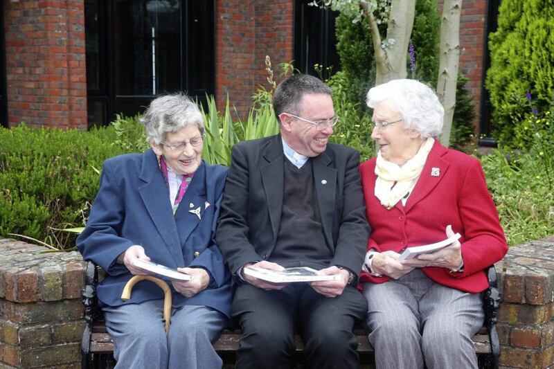 Trea O Boyle and Eileen McKenna, sisters of Sr Paschal, who was one of the last Poor Clares in Belfast, with Fr Martin Magill. Picture by Mal McCann 