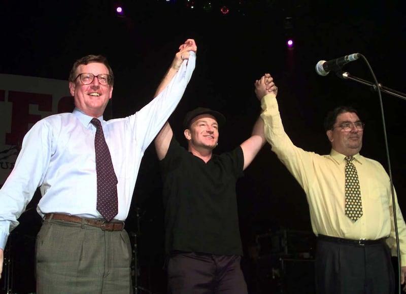 U2 rock star Bono is flanked by UUP leader David Trimble (left) and SDLP leader John Hume on stage during a special concert in Belfast to promote the "Yes" vote in the peace referendum in Northern Ireland.