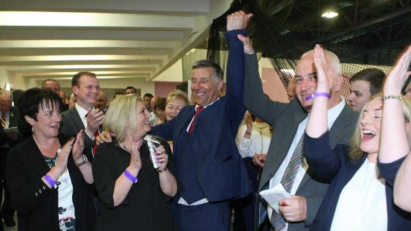 Paul Girvan's arm is raised in triumph after the DUP man topped the poll in South Antrim. Picture by Matt Bohill
