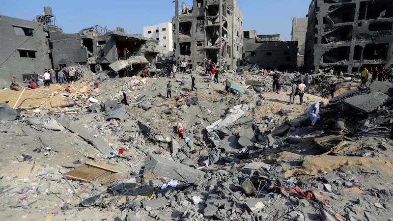 Palestinians wander among debris of buildings that were targeted by Israeli airstrikes in Jabaliya refugee camp, northern Gaza Strip (Abed Khaled, AP)