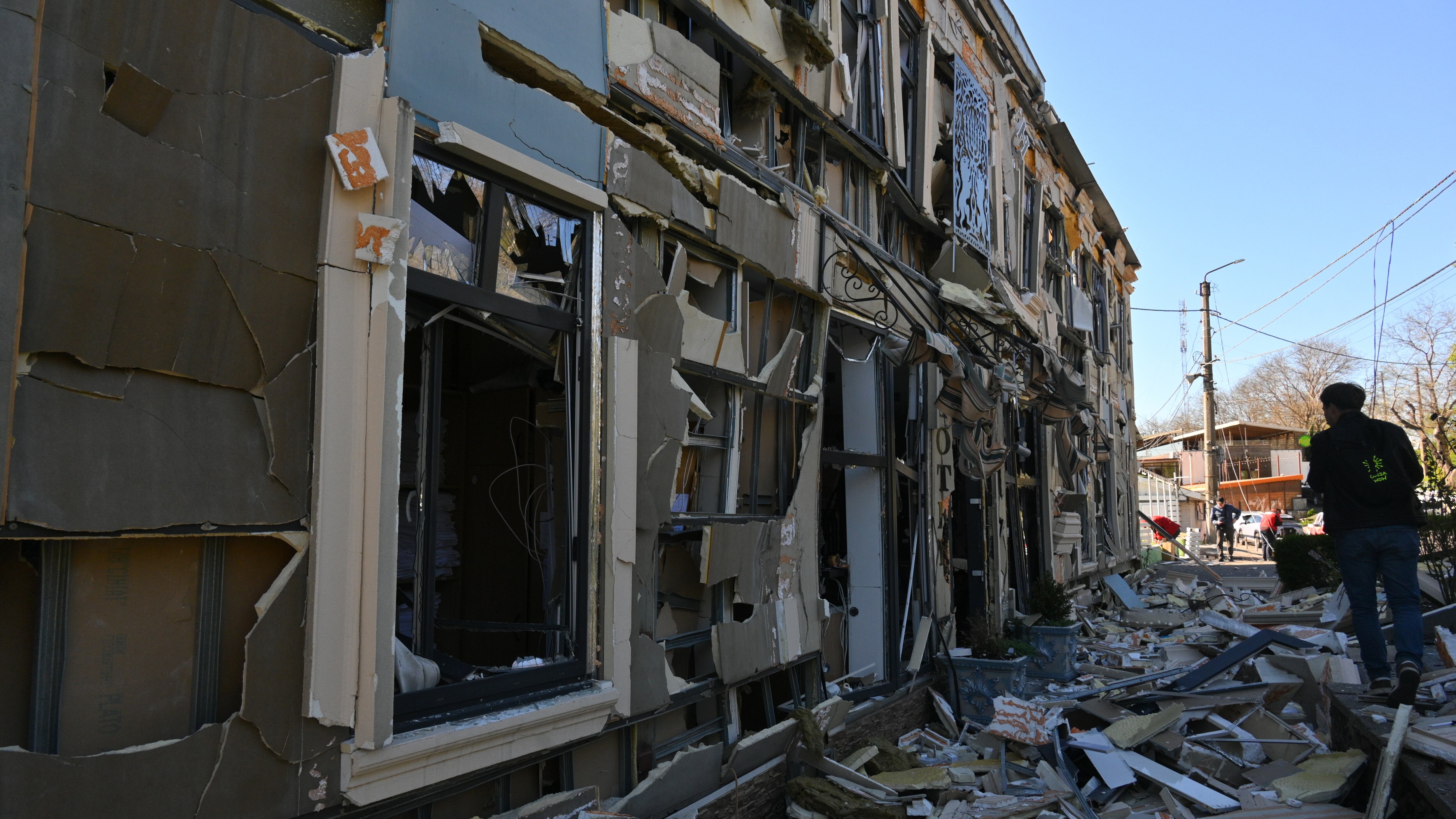 A person walks near residential houses damaged by a Russian strike in Odesa (Michael Shtekel/AP)