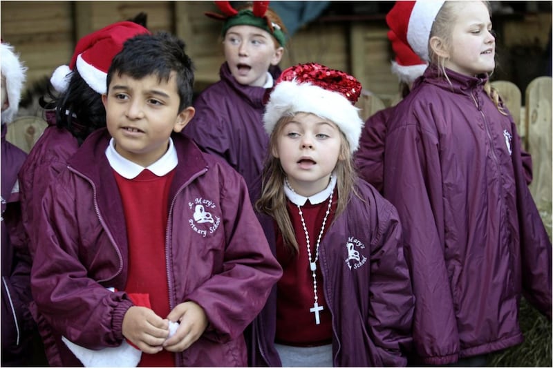 The choir from St Mary&#39;s Primary School in Belfast sing at the live crib at St Mary&#39;s Church on Chapel Lane in the city. Picture by Hugh Russell 