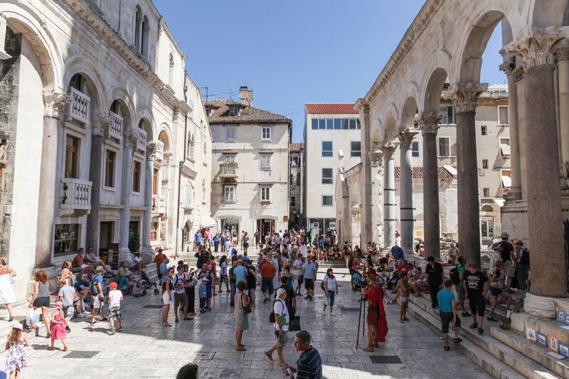 Tourists at the entrance of the Palace of Diocletian, Split, Croatia (Alamy/PA)