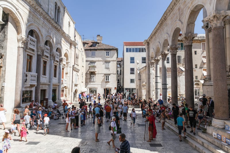 Tourists at the entrance of the Palace of Diocletian, Split, Croatia (Alamy/PA)