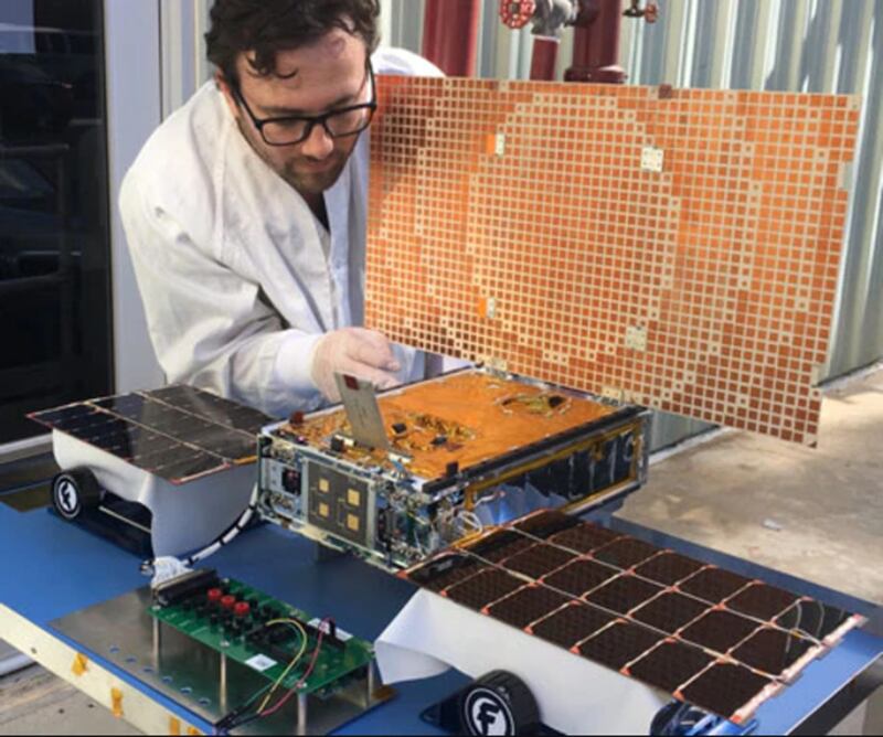 JPL engineer Joel Steinkraus works with one of the MarCO CubeSats