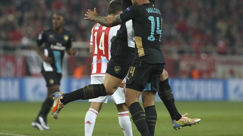 Arsenal's Olivier Giroud, top, celebrates with his teammate Theo Walcott after completing his hat-trick against Olympiakos&nbsp;