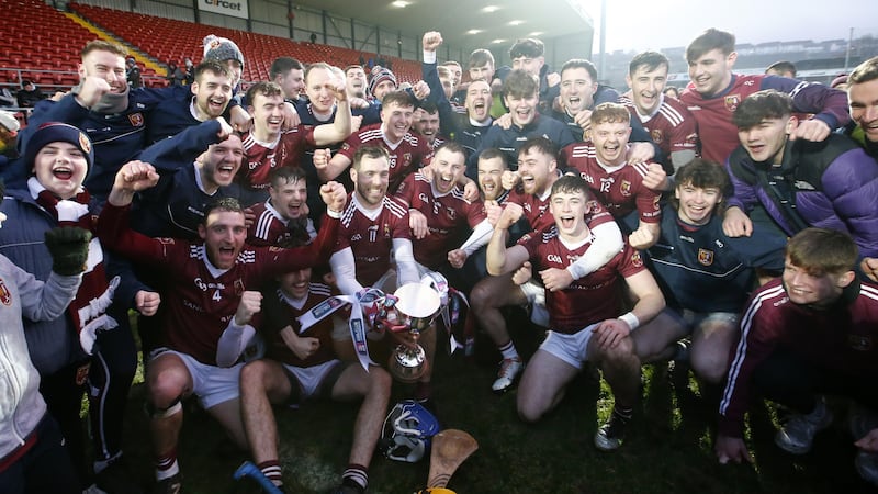 The Cushendall players celebrate with the Four Seasons Cup after Sunday's Ulster final win over Slaughtneil