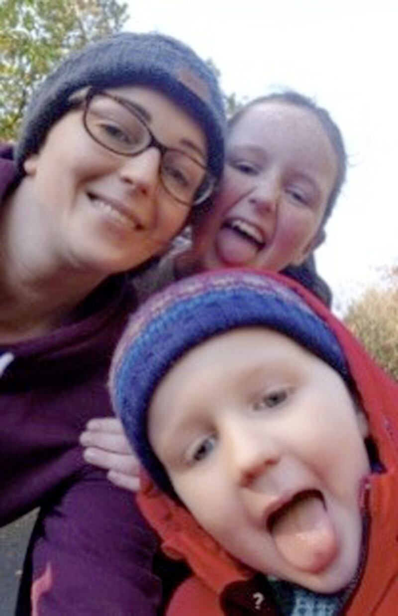 Conor McNeill (front) with mum Karen and sister Grace. Picture from Karen McErlean 