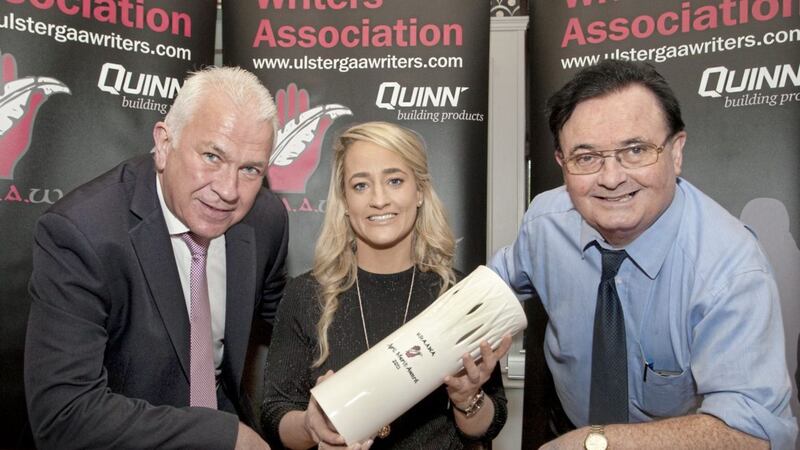 Cavan footballer Donna English receives the April Merit Award from Quinn Sales &amp; Marketing Director Seamus McMahon (left) and former UGAAWA chairman Sean McMahon. Picture by Jim Dunne 