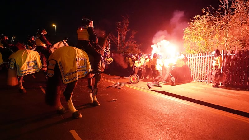 Police attempt to put out flares thrown towards them outside the stadium before the Uefa Europa Conference League Group E match at Villa Park, Birmingham (David Davies/PA)