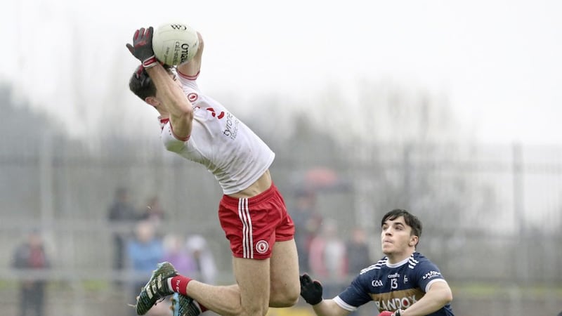Tyrone&#39;s Conan Grugan fields a high ball as Lee Brennan of UU looks on during the McKenna Cup match at Healy Park, Omagh on Sunday Picture by Margaret McLaughlin 