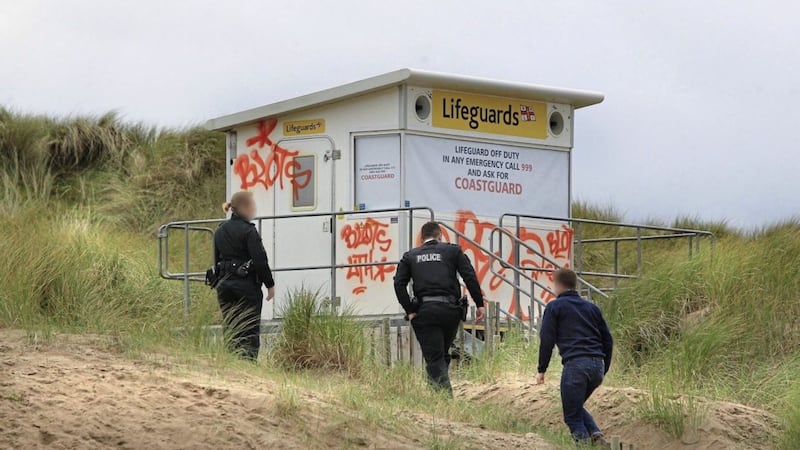 Police view the vandalism at the lifeguard hut and other areas on Portstewart Strand in Co Derry. Picture by Margaret McLaughlin 
