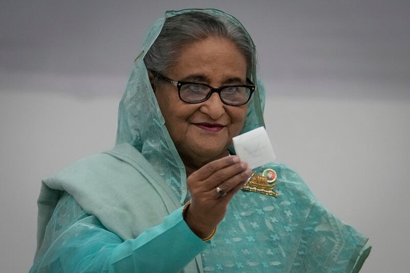 Bangladesh prime minister Sheikh Hasina shows her ballot paper (Altaf Qadri/AP)