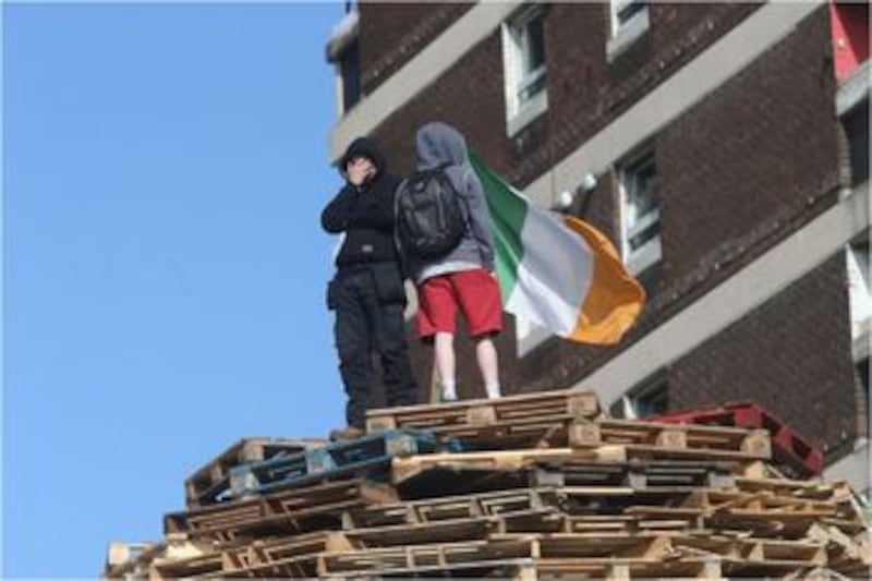 Youths on top of the New Lodge bonfire. Picture by Hugh Russell&nbsp;