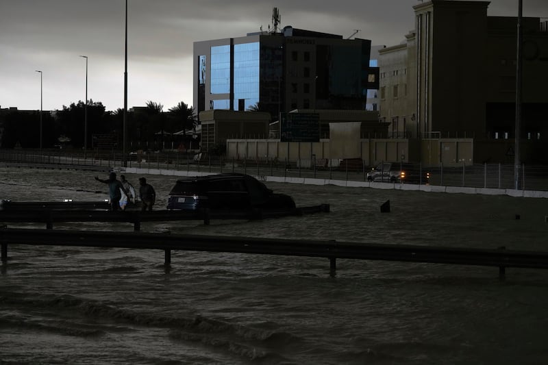 Parts of major highways were flooded and vehicles were left abandoned on roadways across Dubai (Jon Gambrell/AP)