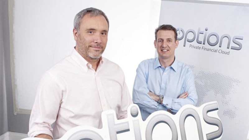 Announcing its original entry into Belfast nearly a decade ago is Options Technologies&#39; Danny Moore (left) with Barry McBride from Invest NI. Options has just acquired financial market data specialist Activ, signalling further job growth in Belfast 