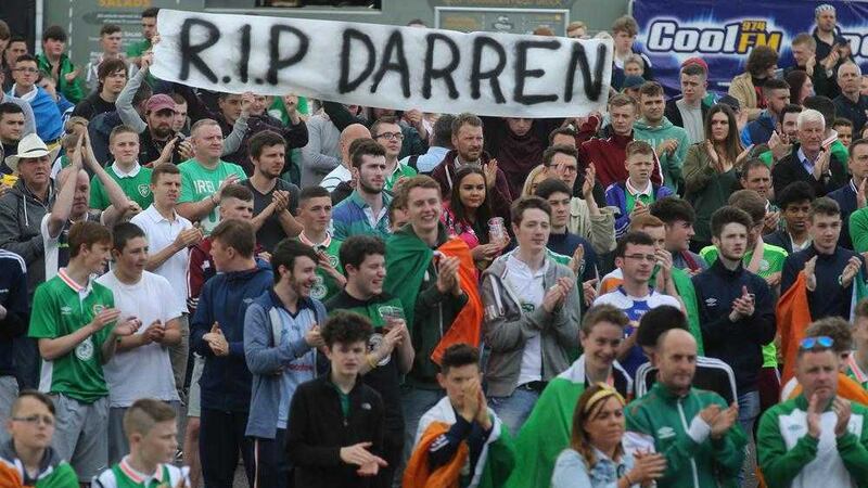 Irish fans pictured at the Fanzone at Titanic Belfast holding a banner reading &#39;RIP Darren&#39;, in memory of Northern Ireland fan Darren Rodgers, who tragically died earlier this month while in France for Euro 2016. Picture by Hugh Russell 