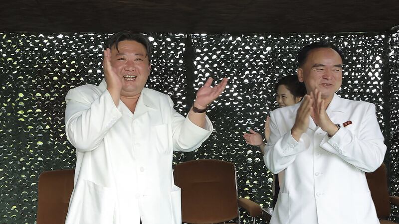 North Korean leader Kim Jong Un, left, claps while watching what North Korea says is the test-firing of a Hwasong-18 ICBM (Korean Central News Agency/Korea News Service via AP)