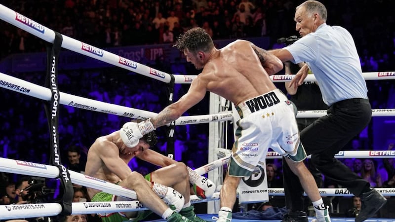 Michael Conlan falls out of the ring after being knocked out by Leigh Wood in their WBA Featherweight World Title contest at the Motorpoint Arena, Nottingham. Picture by Zac Goodwin/PA Wire 