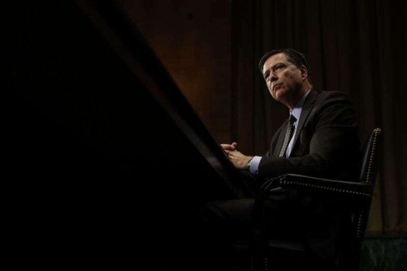 FBI Director James Comey listens while testifying on Capitol Hill