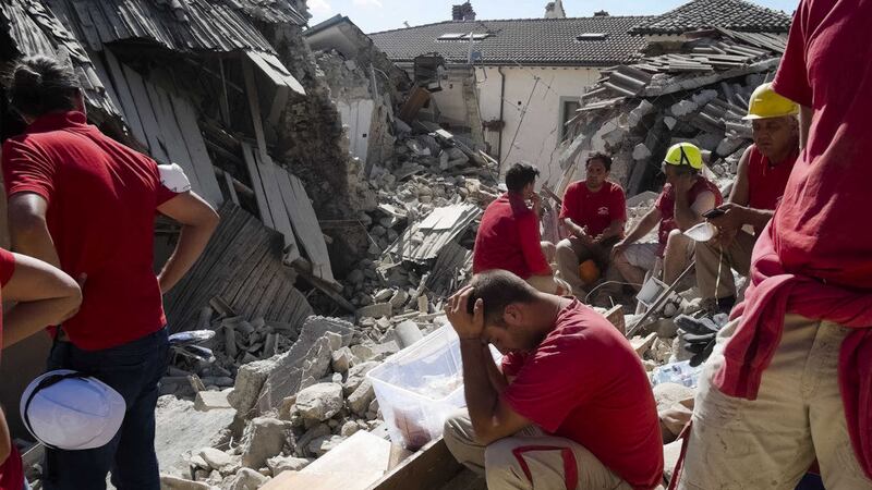 Rescuers pause in Amatrice, central Italy, where a 6.1 earthquake struck just after 3:30 a.m., Wednesday, Aug. 24, 2016. (AP Photo/Emilio Fraile)