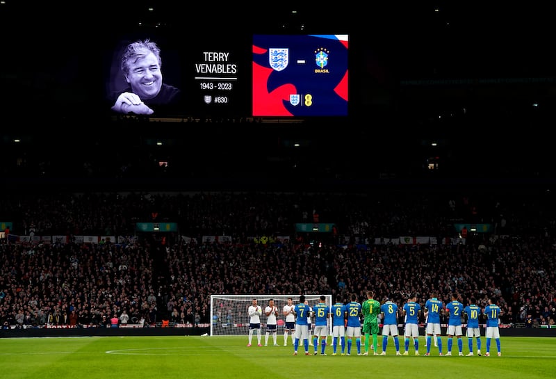 Players and fans take part in a minute’s applause in memory of former England manager Terry Venables