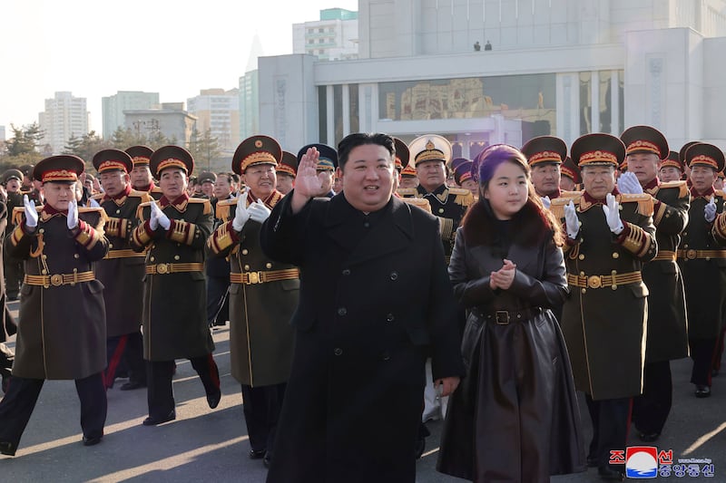 Kim Jong Un, with his daughter, waves as he visits the defence ministry in a photo provided by the North Korean government (Korean Central News Agency/Korea News Service/AP)
