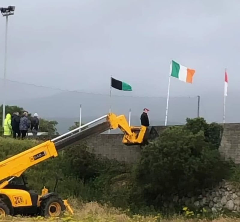 Ain't no mountain high enough. With no spectators allowed because of Covid, Emmett Haughian watches a game from the bucket of a low loader