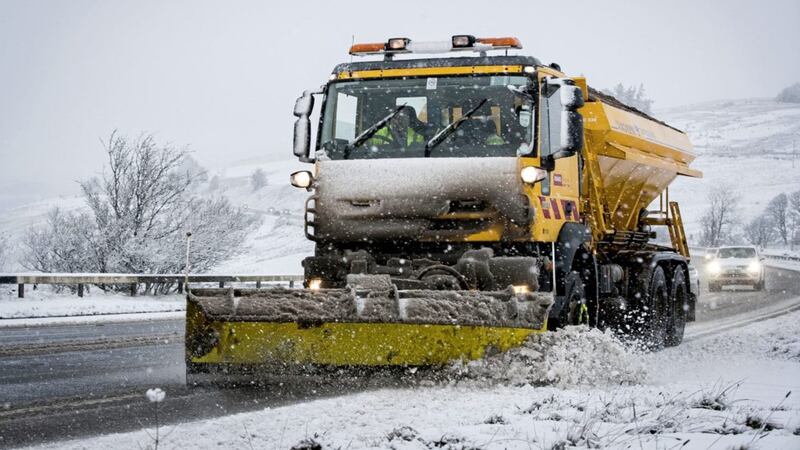 A gritter from the Northern Ireland Department of Infrastructure clears the road during heavy snowfall on the Glenshane Pass in Co Derry Picture by Liam McBurney/PA 
