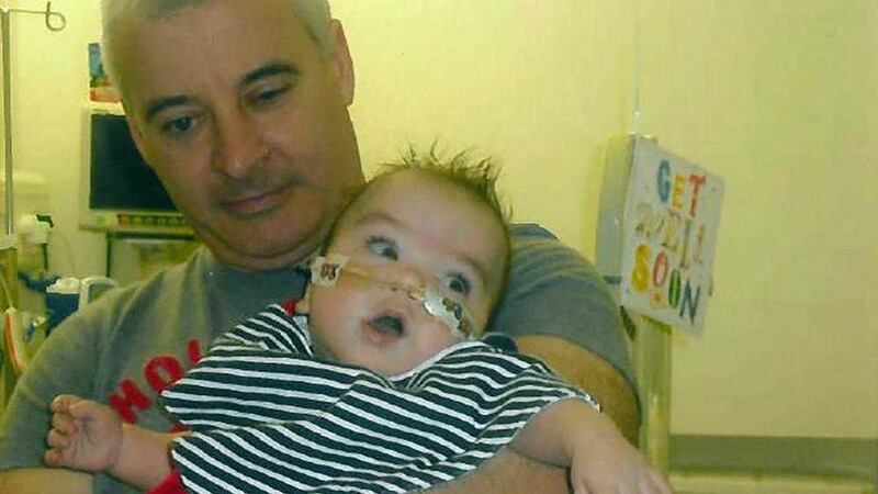 Kevin McGuigan, with his grandson Ollie, who was in hospital in 2011 