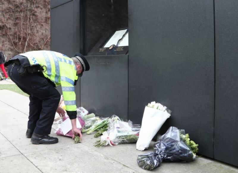 police lay flowers at a memorial (Gareth Fuller/PA)
