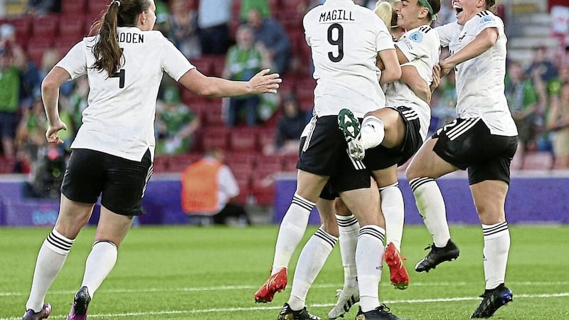 Northern Ireland&#39;s Julie Nelson (hidden) is mobbed by team-mates after scoring their side&#39;s first-ever goal in a major finals 